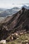 Vertical shot of mountain goats on the sunny hills