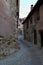 Vertical shot of a narrow alley through historic buildings in Albarracin, Spain