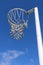 Vertical shot of a netball hoop against a blue sky