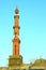 Vertical shot of a new mosque and minaret under construction