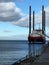 Vertical shot of the offshore vessel in the calm sea against the blue sky