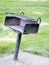 Vertical shot of an old abandoned broken mailbox