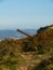 Vertical shot of an old abandoned coastal defense cannon in Bilbao, Spain