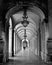 Vertical shot of an old archway corridor with unlit lanterns. Perfect for wallpaper or background