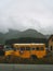 Vertical shot of an old campers school bus parked in Pitomine, Montenegro