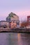 Vertical shot of an old Ulster Bank office in front of a river at the sunset in Dublin, Ireland