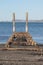 Vertical shot of an old wooden structure on the coast of the sea