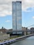 Vertical shot of the One Manhattan Square skyscraper on the side of a lake in New York