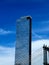 Vertical shot of One Manhattan Square tower on a sky and clouds background