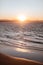 Vertical shot of an orange sunset sky over Little Wategos Beach in Byron Bay, Australia