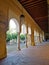 Vertical shot of an outdoor corridor with arches od a historic building in Cordoba, Spain