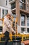 Vertical shot of overweight woman in warm hat and jacket using antibacterial wet wipes to clean disinfect hands and