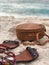 Vertical shot of a pair of sandals and a wicker bag on the sand of a beach in Nassau, Bahamas