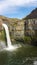 Vertical shot of the Palouse Falls with the rainbow over it in the United States