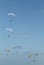 Vertical shot of people on parachutes flying up in the air