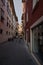 Vertical shot of people walking through a narrow alley of buildings in Riva del Garda, Italy