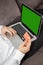 Vertical shot of a person inputting details of its credit card in the laptop