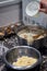 Vertical shot of a person preparing tortillas with cheese on a table in the kitchen