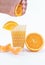 Vertical shot of a person squeezing orange into a glass isolated on a white background