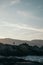 Vertical shot of a person standing on the rocks in the Arousa Island,  Galicia, Spain