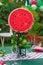 Vertical shot of picnic tables decorated with watermelon