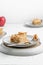 Vertical shot of a piece of crispy pie in a plate on the table