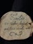 Vertical shot of a piece of wood with a german quote about family on it