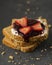 Vertical shot of pieces of yeast bread with jam, yogurt and strawberries