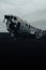 Vertical shot of the plane wreck at Solheimasandur in a gloomy field in Iceland under a stormy sky