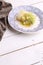 Vertical shot of plate with romanesco vegetable dish on wooden background