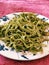 Vertical shot of a plate of Spinach pasta