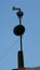Vertical shot of a pole with speakers on a blue sky background