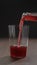 vertical shot pour berry soft drink in tumbler glass on wood table with copy space
