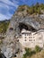 Vertical shot of the Predjama Castle built within a cavemouth in Predjama, Slovenia