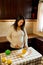 Vertical shot of a pregnant Latina woman cutting a grapefruit in half to make a natural juice. Concept of healthy eating during