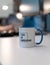 Vertical shot of a printed text CSS IS AWESOME in the mug with a blurred background