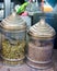 Vertical shot of pumpkin and cumin seeds on individual huge glass jars displayed in a store