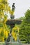 Vertical shot of the Queen Victoria Memorial Fountain with golden chain flowers in Halifax, Canada