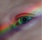 Vertical shot of the real rainbow on a blue female eye - seeing the world in color concept