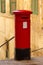 Vertical shot of the red pillar letterbox at Mikiel Anton Vassalli Street in Valletta, Malta