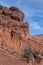 Vertical shot of red rock formation and side of cliff in rural New Mexico