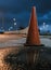 Vertical shot of the reflection of a traffic cone on the wet street