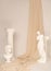 Vertical shot of the Renaissance epoch gypsum statues arranged with fabric on white background