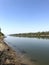 Vertical shot of the river surrounded by trees, land and forest