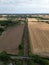 Vertical shot of a road separating cultivated fields from an aerial view