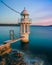 Vertical shot of Robertson Point Light in Sydney surrounded by blue water in the evening