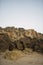 Vertical shot of rock formations on the beach under the sunlight in Cala Roche, Spain