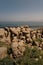 Vertical shot of rock formations near the shore in Punta Carnero, Spain