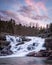 Vertical shot of rocky falls under a beautiful purple sky, Missouri, United Sates