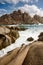 Vertical shot of the rocky shore at Valle della Luna in Sardinia Island, Italy under a cloudy sky